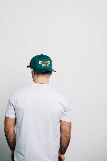 Man wearing a Hidden Bigfoot Hat showing off a fun Bigfoot-themed design.