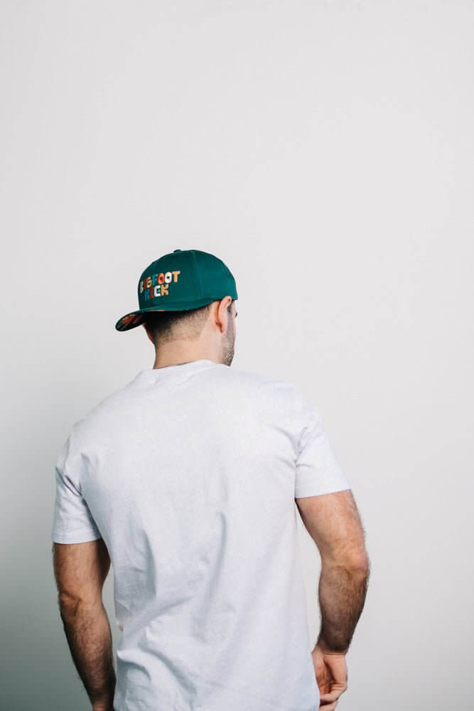 Person wearing a Hidden Bigfoot Hat, showcasing its unique design from the back view.