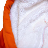 Inside view of the Squatchfuzz Tiger Hoodie showcasing its soft white lining and vibrant orange exterior.